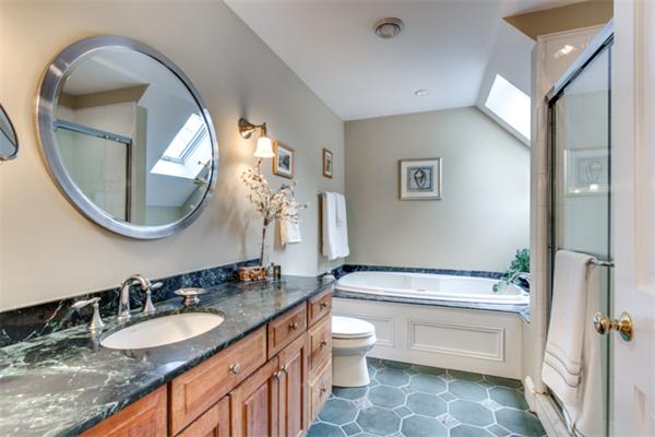 27 Percy Road Lexington, MA 02421 - Photo 8 of 17 a bathroom with a granite countertop toilet a sink and a mirror