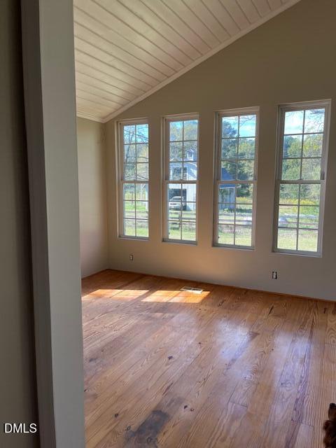 6663 Harold Obrien Road Oxford, NC 27565 - Photo 19 of 41 an empty room with wooden floor and windows