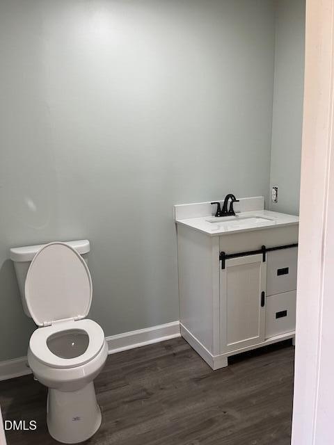 6663 Harold Obrien Road Oxford, NC 27565 - Photo 23 of 41 a bathroom with a toilet a sink and wooden floor