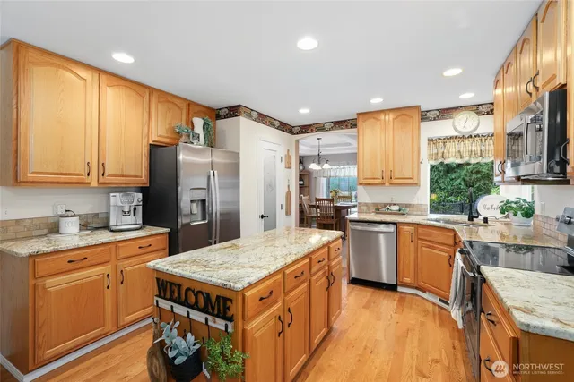 a kitchen with a stove a refrigerator and a sink