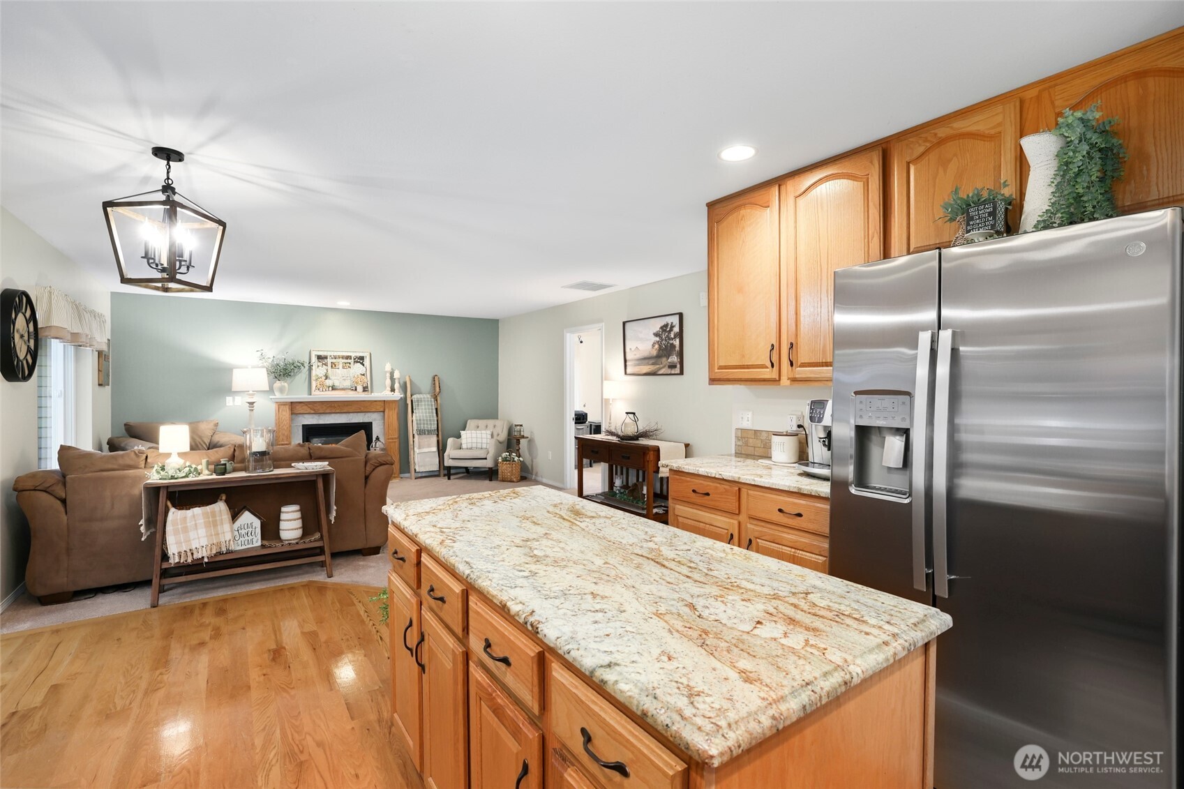 12722 247th Street East Graham, WA 98338 - Photo 13 of 40 a kitchen with sink refrigerator and stove