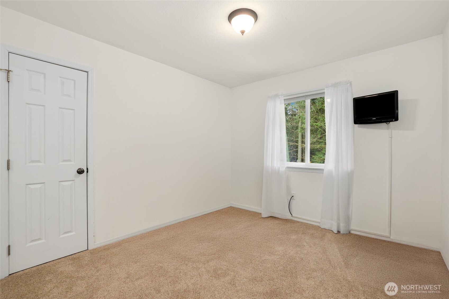 12722 247th Street East Graham, WA 98338 - Photo 17 of 40 an empty room with windows and television