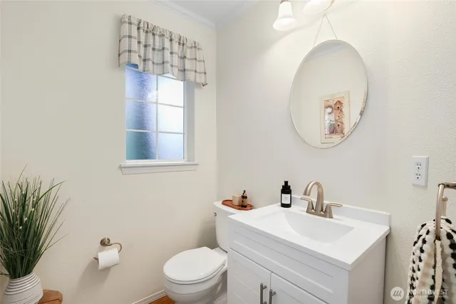 a bathroom with a toilet a sink and a mirror