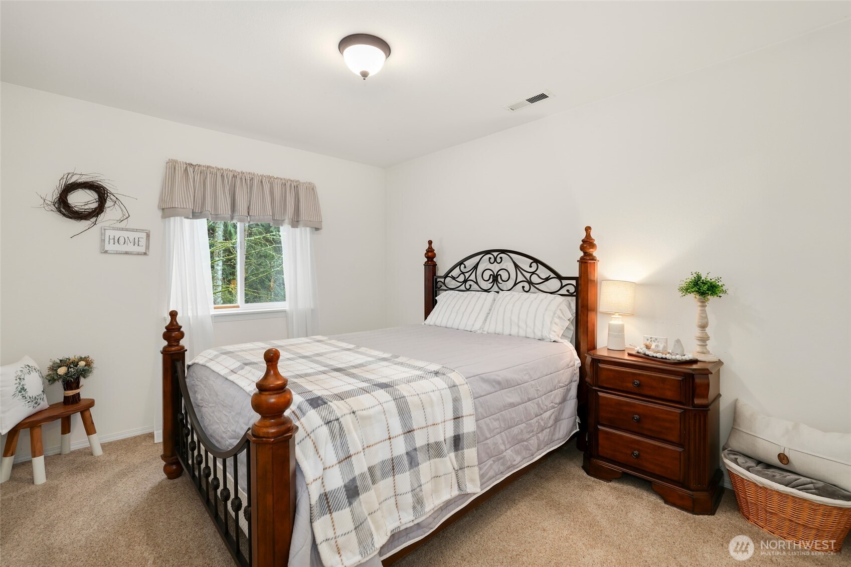 12722 247th Street East Graham, WA 98338 - Photo 24 of 40 a bedroom with a bed and a chandelier