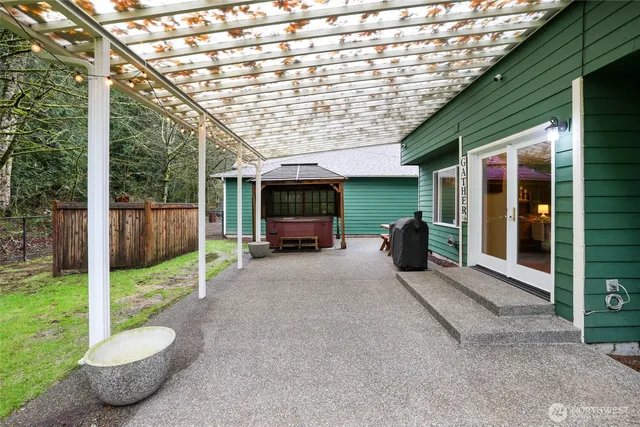 a view of a patio with table and chairs next to a yard