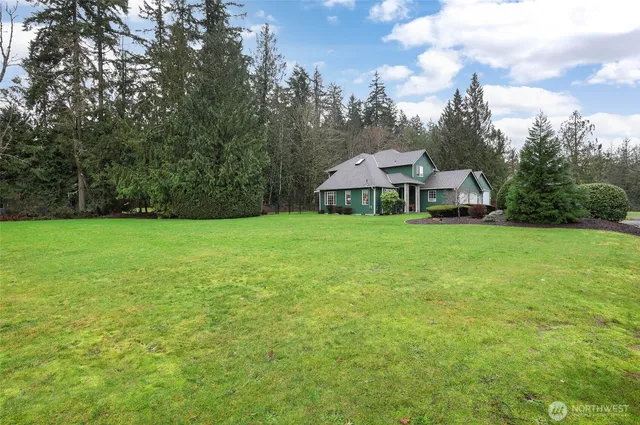 a view of a house with a yard and sitting area