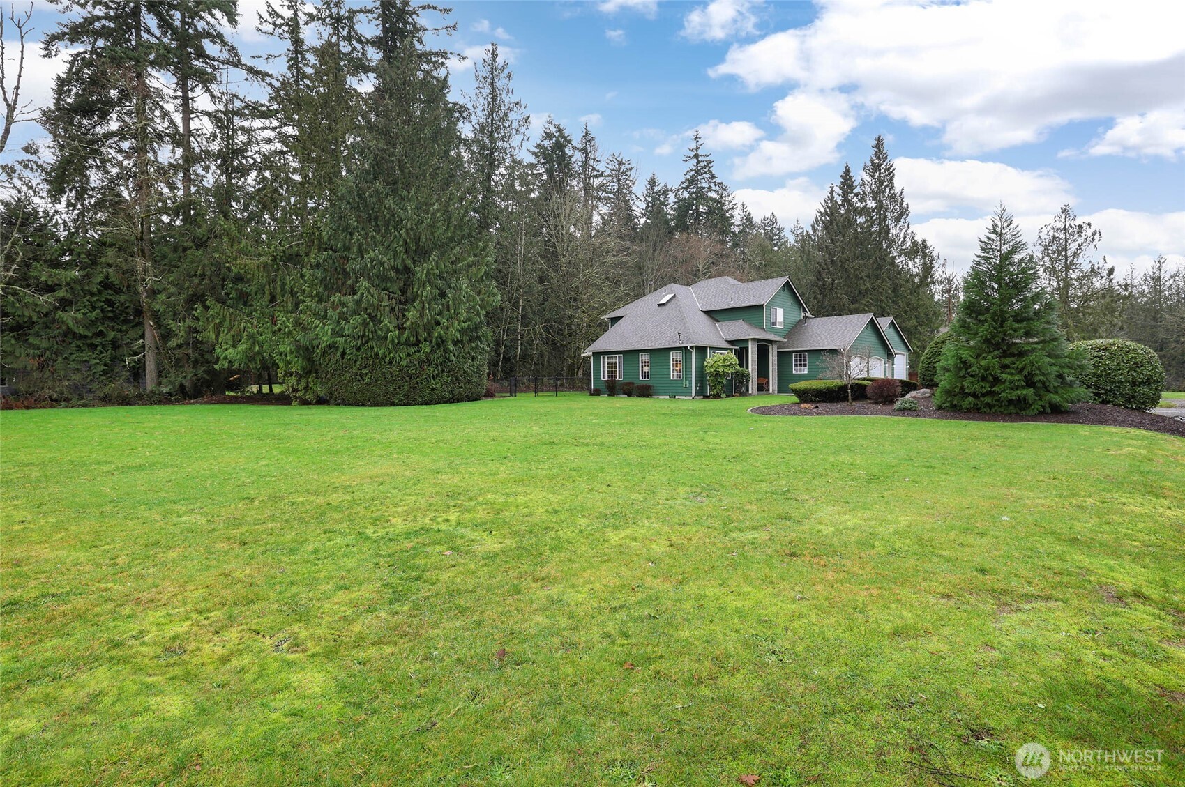 12722 247th Street East Graham, WA 98338 - Photo 35 of 40 a view of a house with a yard and sitting area