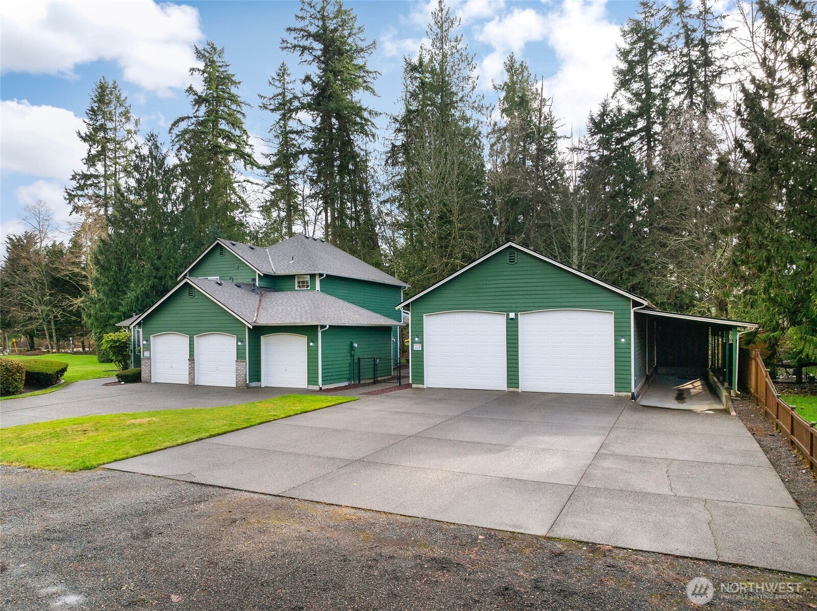 12722 247th Street East Graham, WA 98338 - Photo 4 of 40 a view of a house with a yard and large trees