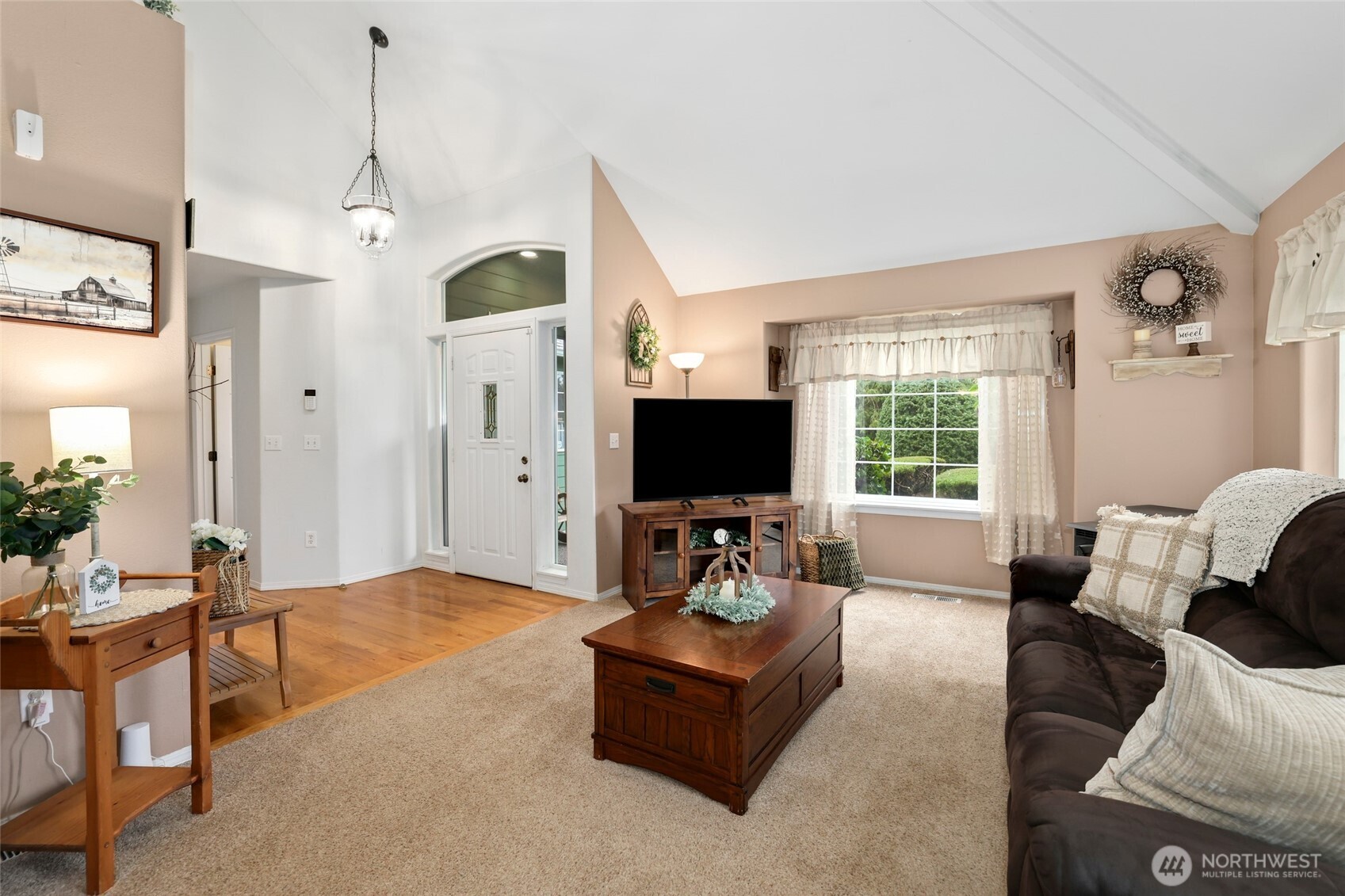 12722 247th Street East Graham, WA 98338 - Photo 7 of 40 a living room with furniture a flat screen tv and a large window