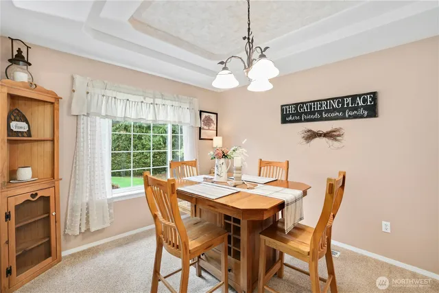 a view of a dining room with furniture window and outside view