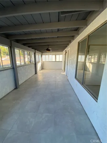 a view of empty room with large windows