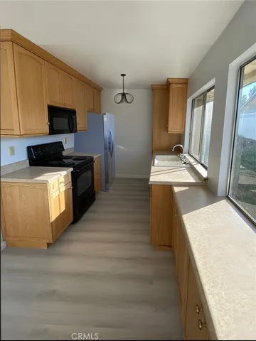 a kitchen with stainless steel appliances wooden cabinets and a counter top space
