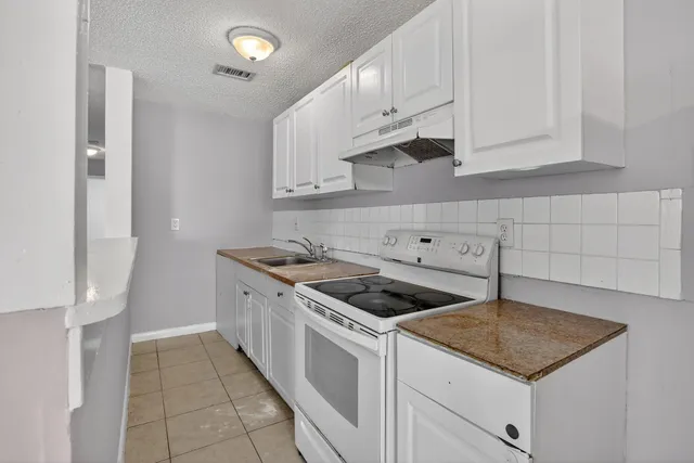 a kitchen with cabinets and appliances