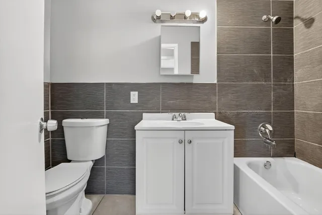 a white toilet sitting next to a white sink