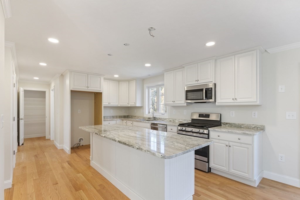 183 Rangeway Road Billerica, MA 01862 - Photo 4 of 14 a kitchen with stainless steel appliances granite countertop a stove a sink and a refrigerator