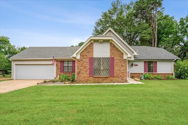 a front view of house with yard and green space