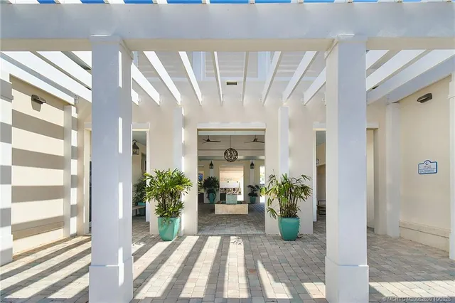 a view of an entryway with wooden floor and a livingroom