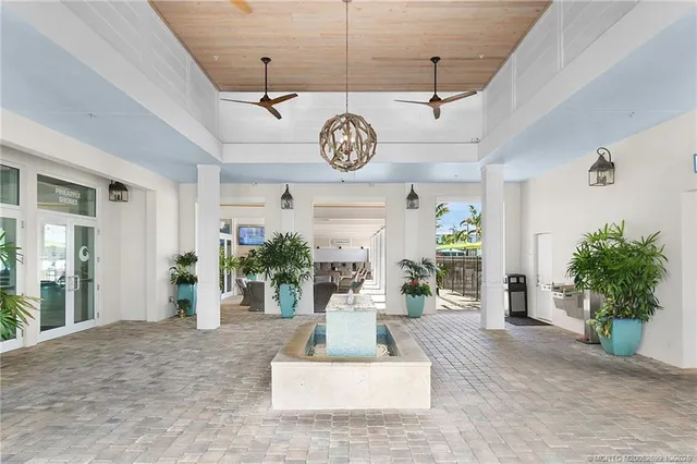 a living room with furniture a chandelier and a window