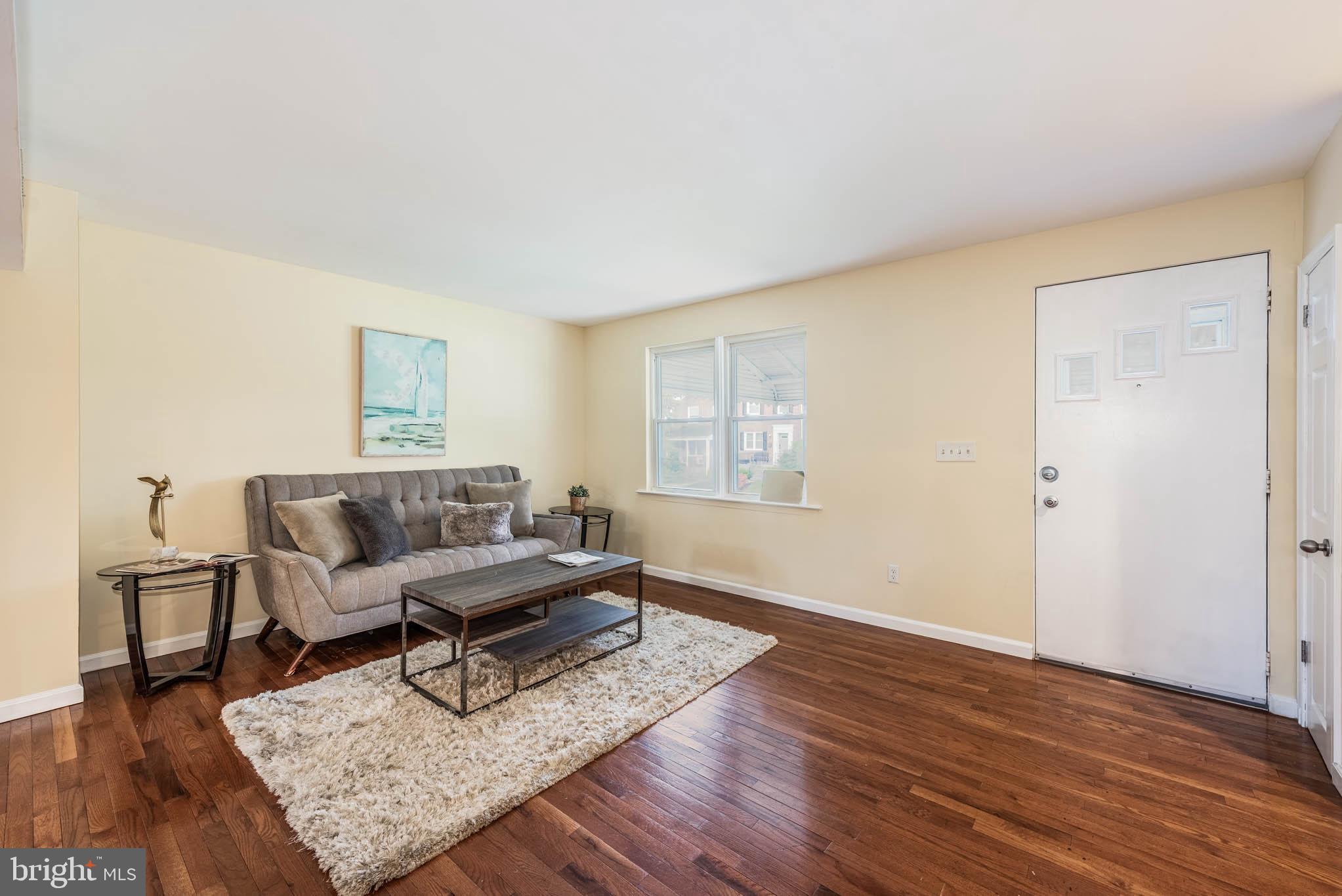 1010 Andover Road Baltimore, MD 21218 - Photo 4 of 34 a living room with furniture and a wooden floor