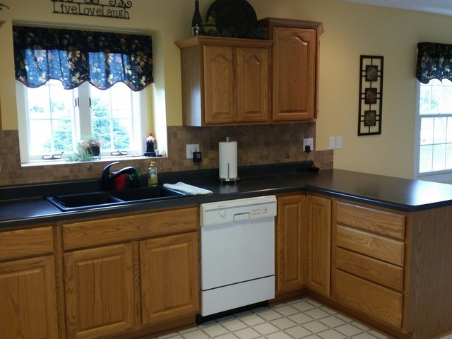 2265 East 20th Road Grand Ridge, IL 61325 - Photo 3 of 25 a kitchen with white cabinets a window and a sink