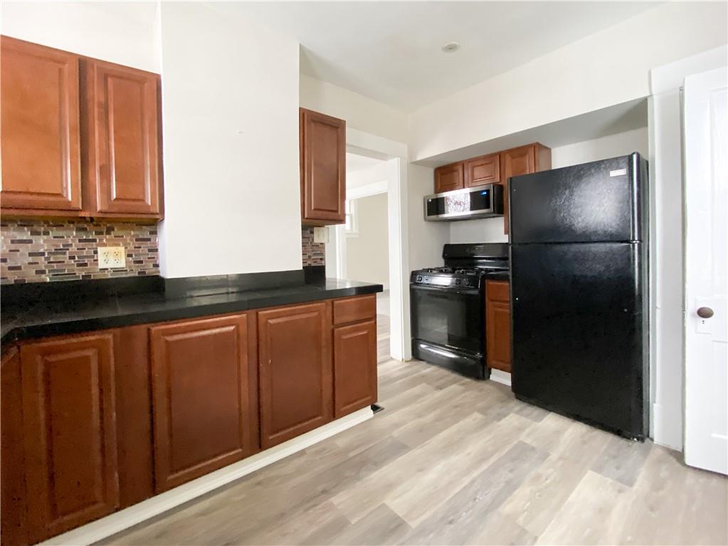 476 Mecklem Avenue Rochester, PA 15074 - Photo 11 of 28 a kitchen with stainless steel appliances granite countertop a refrigerator and a sink
