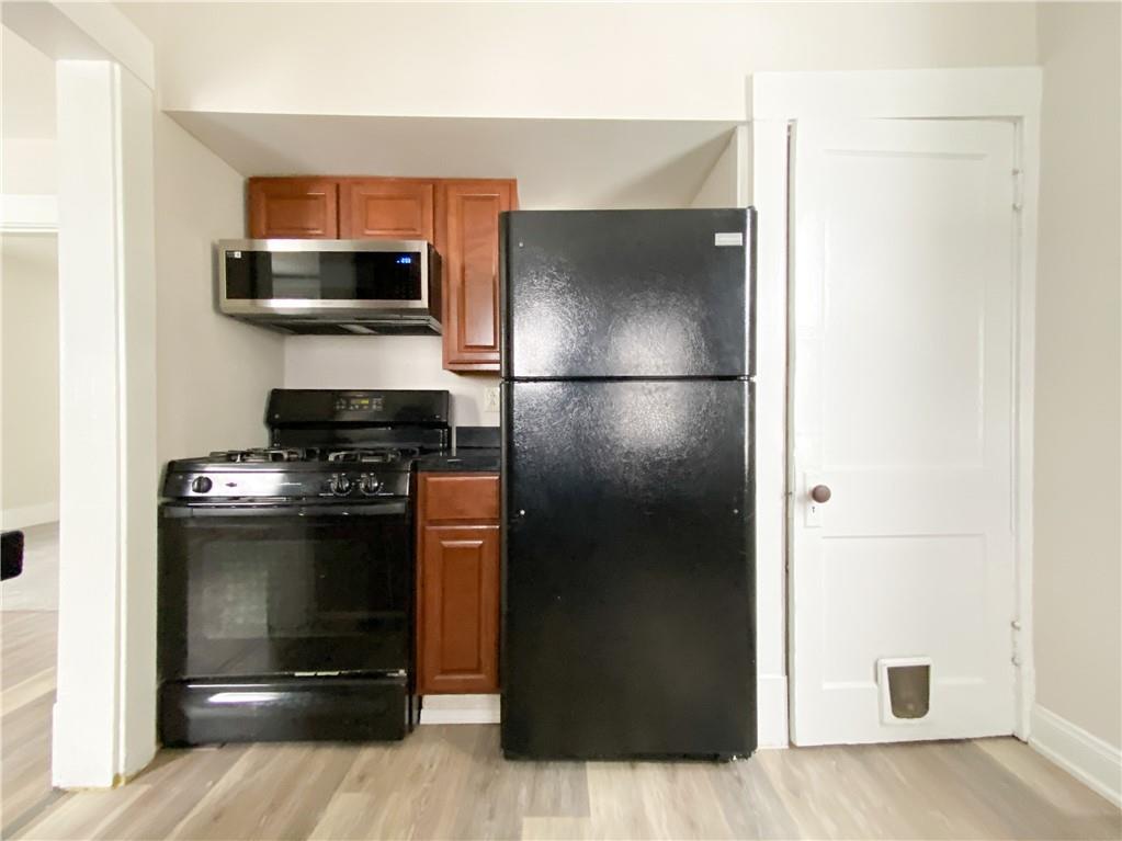 476 Mecklem Avenue Rochester, PA 15074 - Photo 13 of 28 a kitchen with a refrigerator and a stove