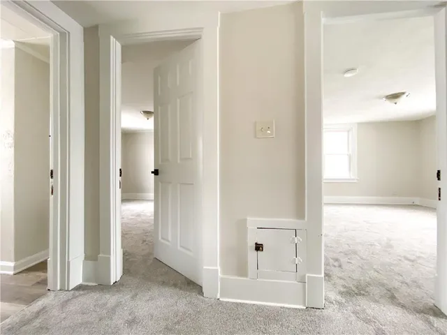 an empty room with mirror and shower