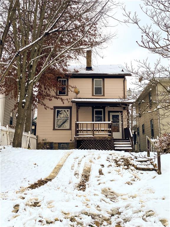 476 Mecklem Avenue Rochester, PA 15074 - Photo 3 of 28 a front view of a house with a yard covered in snow