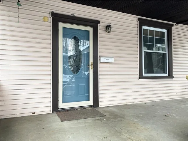 a view of a house with a large window and a door