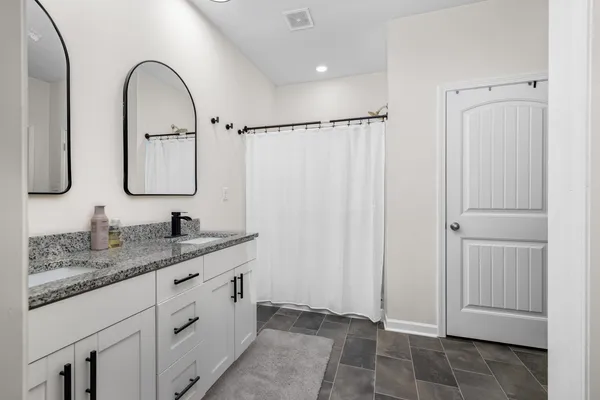 a bathroom with a granite countertop sink mirror and vanity