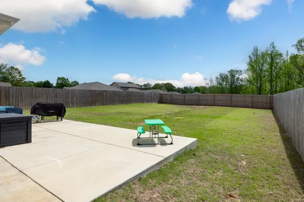 a backyard of a house with lots of green space