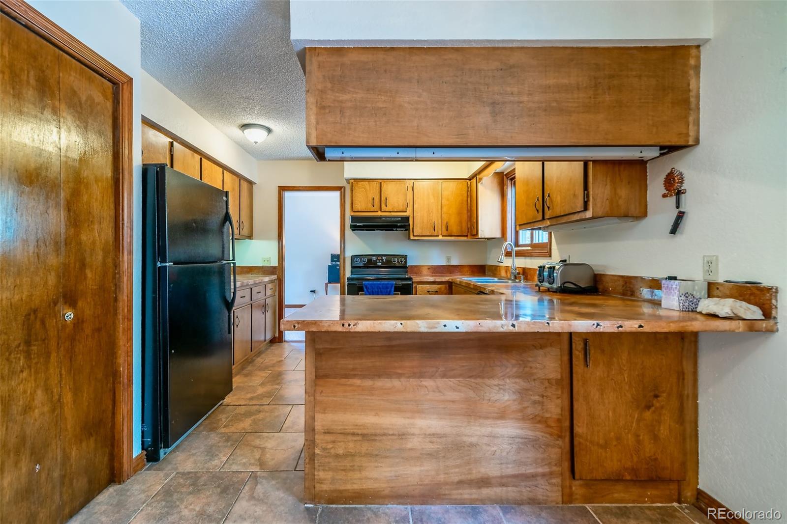 103 County Road 4C-E Leadville, CO 80461 - Photo 19 of 40 a kitchen with stainless steel appliances granite countertop a refrigerator and a sink