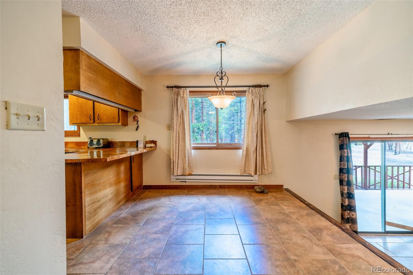 103 County Road 4C-E Leadville, CO 80461 - Photo 28 of 40 a view of a kitchen with a stove cabinets and a floor to ceiling window