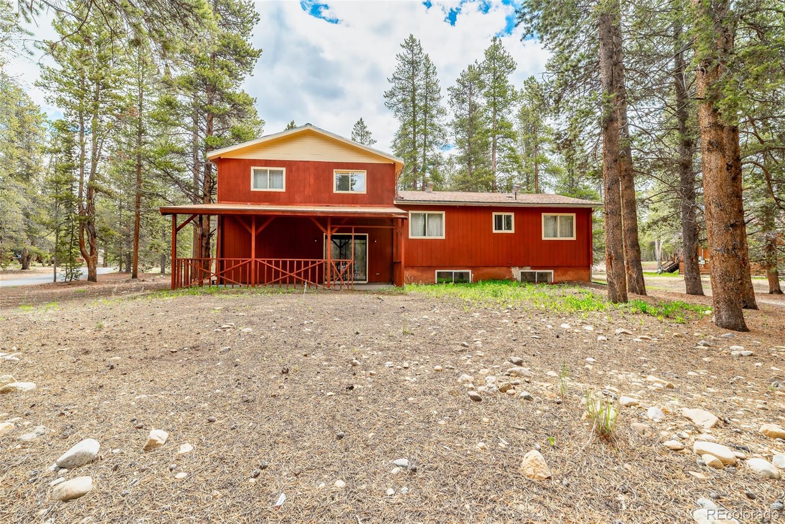 103 County Road 4C-E Leadville, CO 80461 - Photo 8 of 40 a front view of a house with a yard and garage