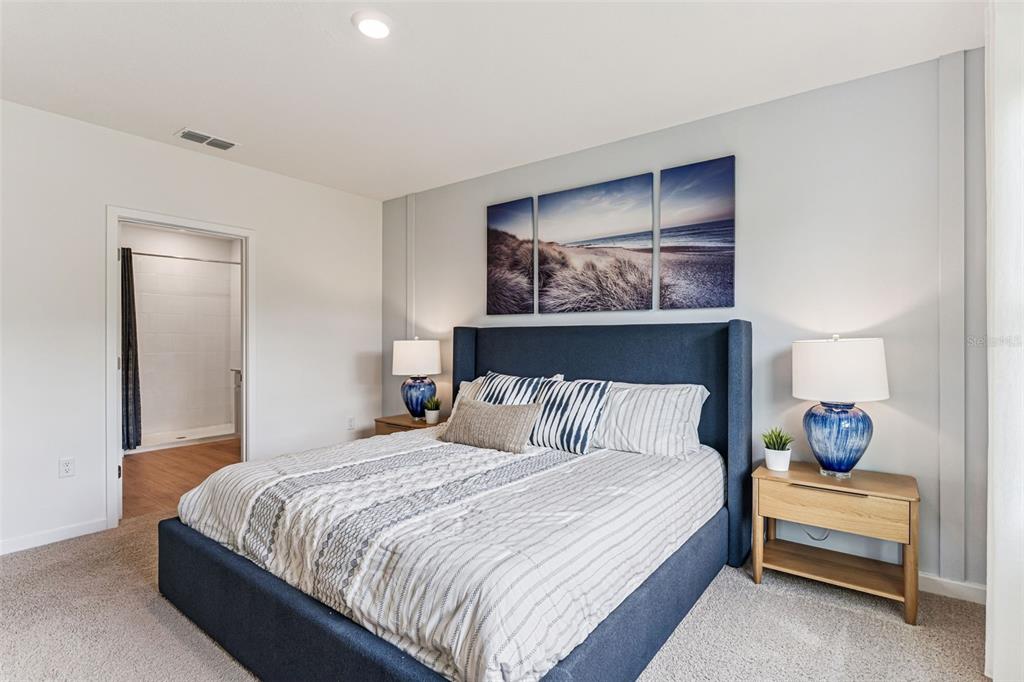 3922 Royal Azalea Way Sanford, FL 32773 - Photo 22 of 42 a bedroom with a bed and lamp