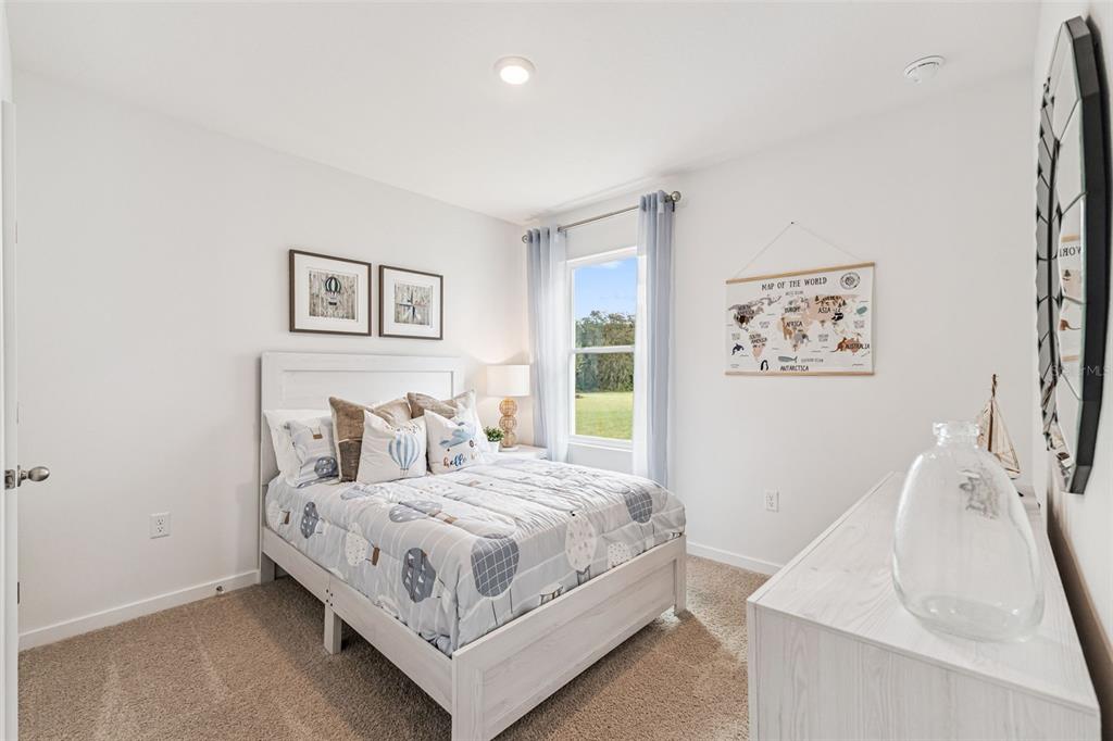 3922 Royal Azalea Way Sanford, FL 32773 - Photo 26 of 42 a bedroom with a bed and painting on the wall