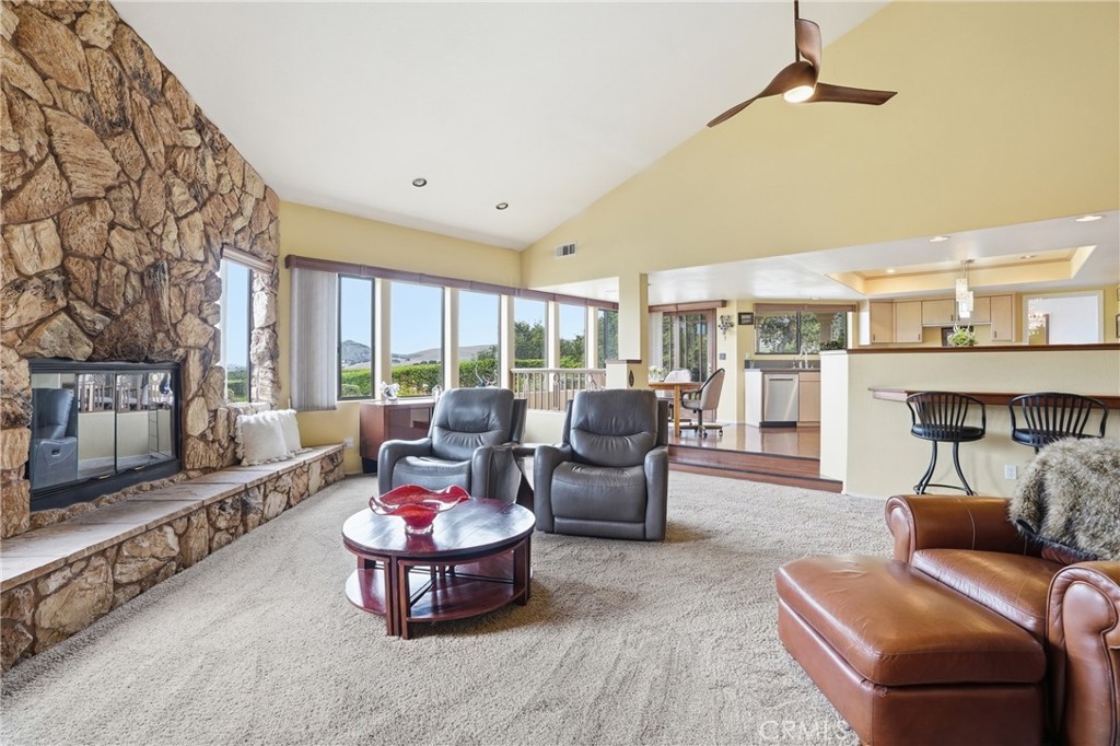 225 Broken Arrow Road Nipomo, CA 93444 - Photo 13 of 45 Family room with floor-to-ceiling stone fireplace adjoins open kitchen and dining bay--all with exquisite views