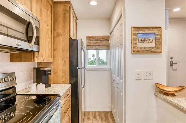 a kitchen with stainless steel appliances granite countertop a refrigerator and a stove