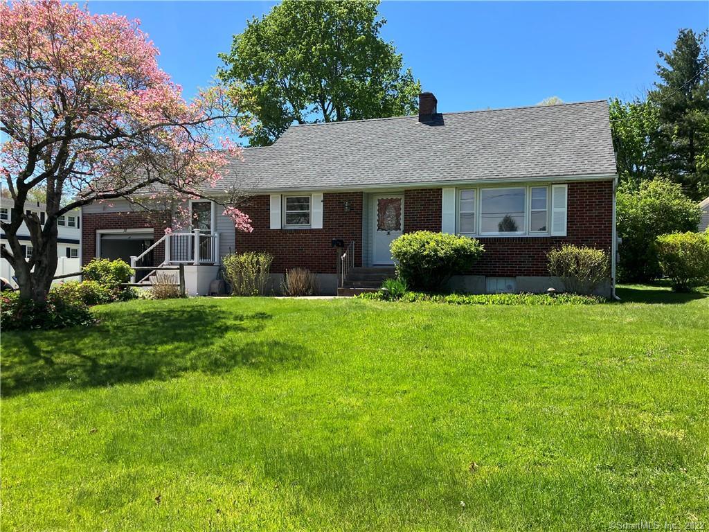 38 Lincoln Road Cromwell, CT 06416 - Photo 1 of 1 a front view of a house with a garden and yard