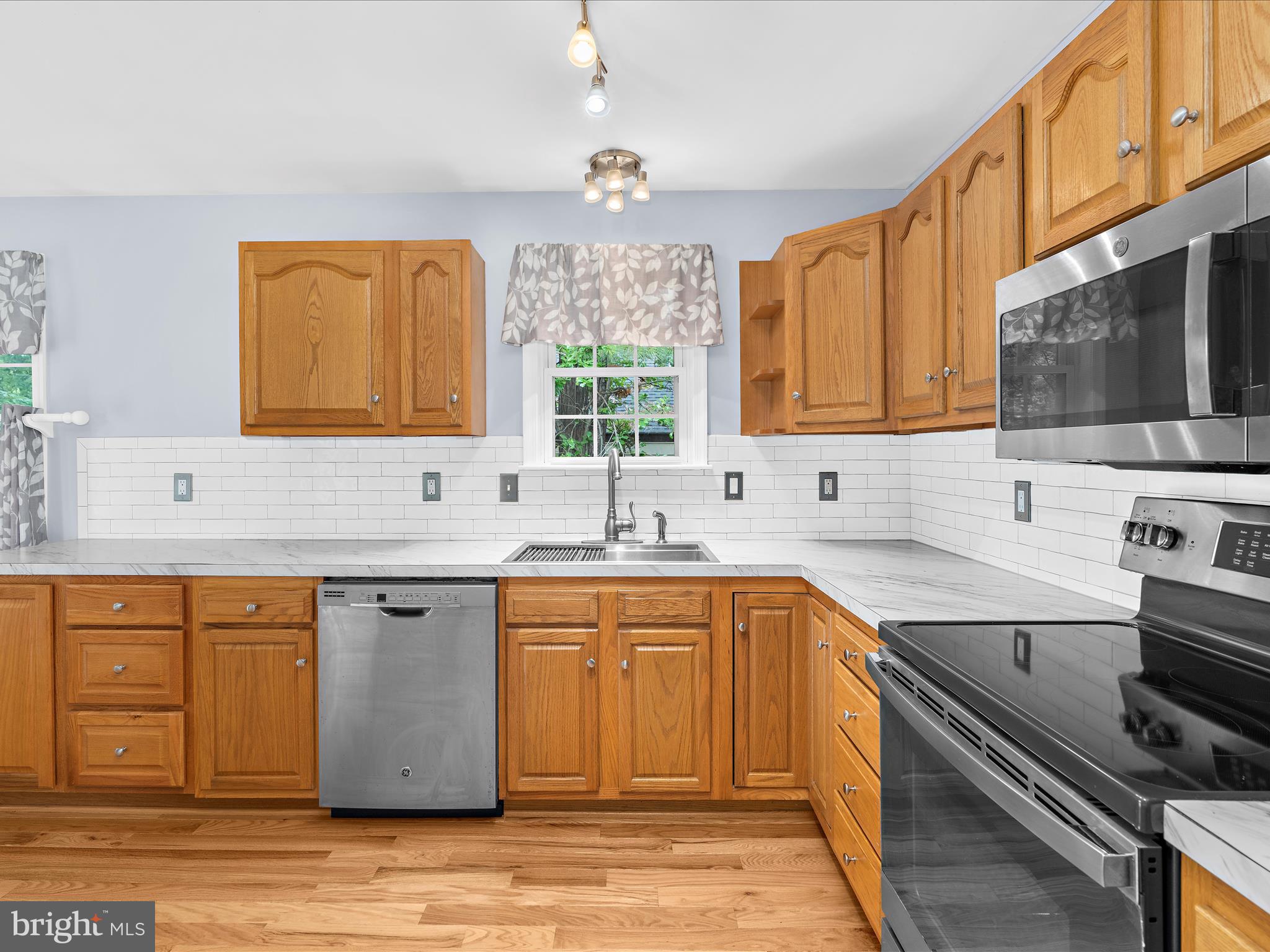 931 Oakleigh Beach Road Baltimore, MD 21222 - Photo 12 of 52 a kitchen with stainless steel appliances granite countertop a sink stove and cabinets