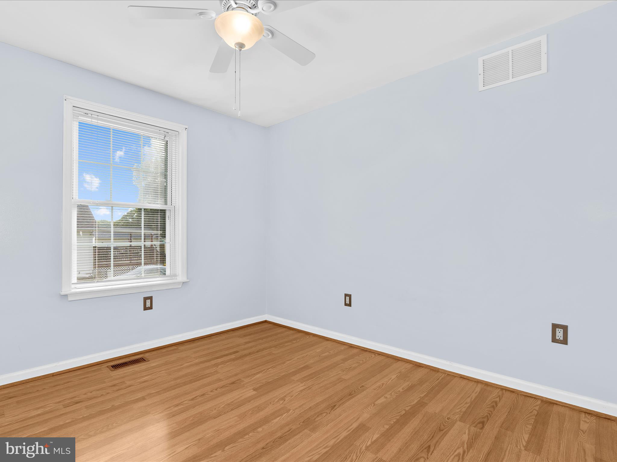 931 Oakleigh Beach Road Baltimore, MD 21222 - Photo 21 of 52 an empty room with wooden floor and windows