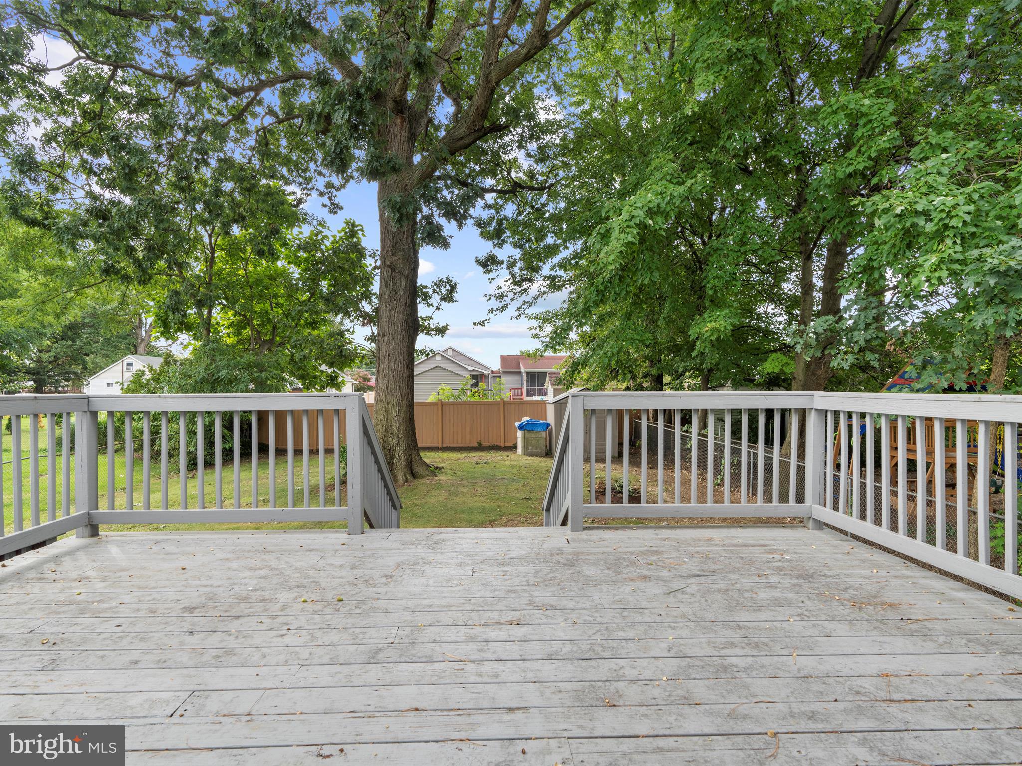 931 Oakleigh Beach Road Baltimore, MD 21222 - Photo 40 of 52 a view of balcony with wooden fence and trees