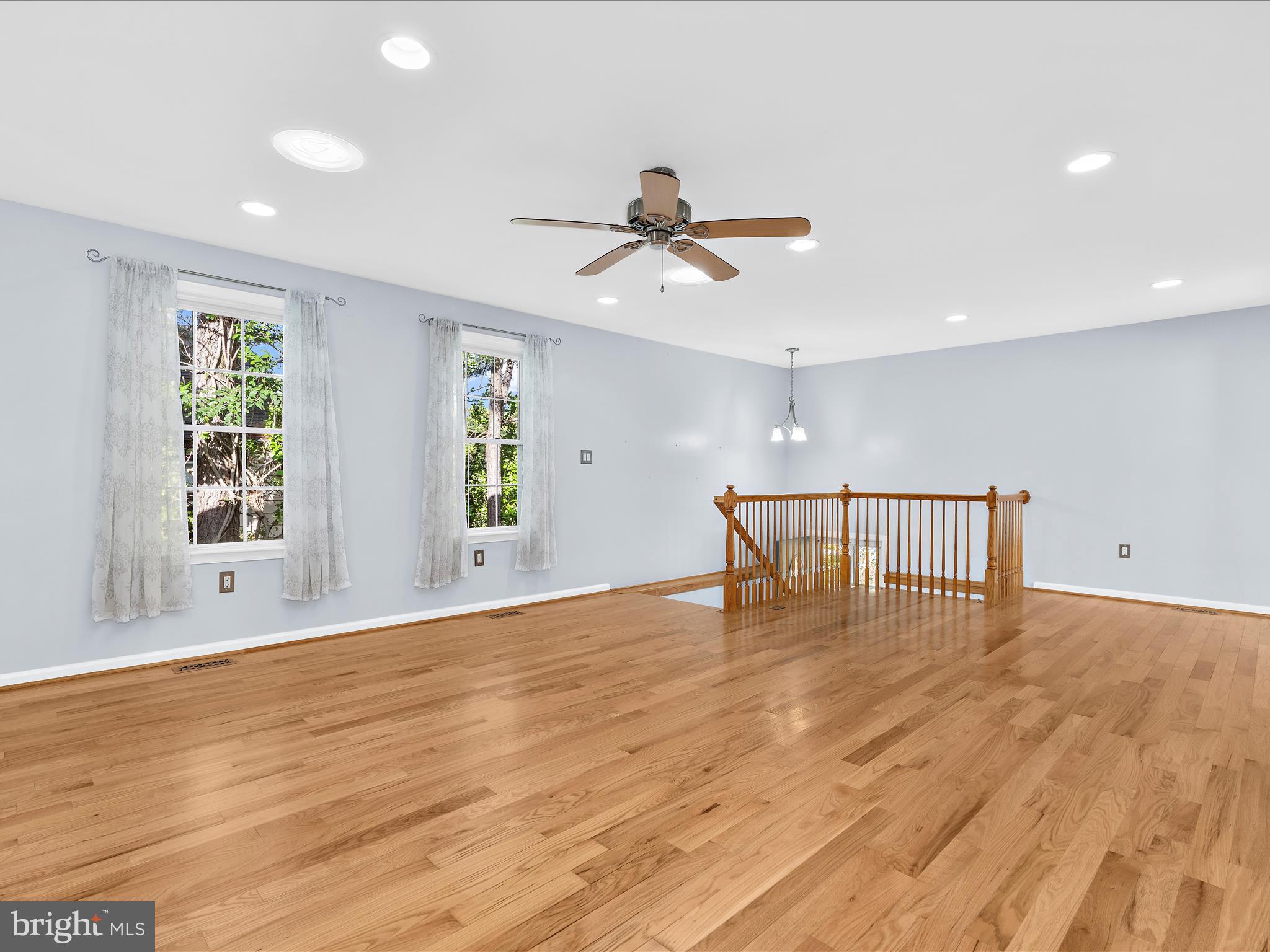 931 Oakleigh Beach Road Baltimore, MD 21222 - Photo 5 of 52 a big room with wooden floor chandelier fan and windows