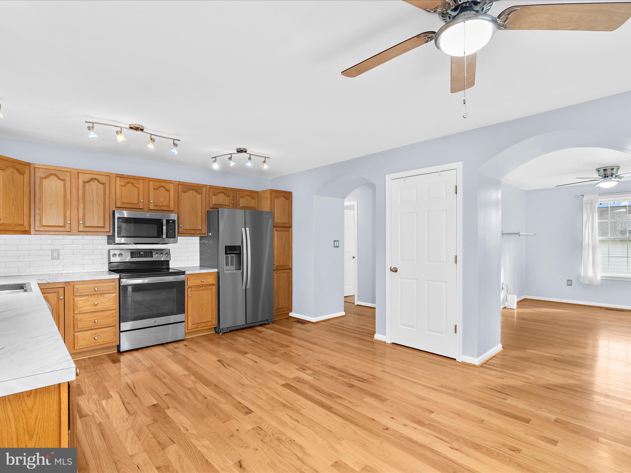 931 Oakleigh Beach Road Baltimore, MD 21222 - Photo 10 of 52 a kitchen with stainless steel appliances kitchen island granite countertop a refrigerator and a stove top oven
