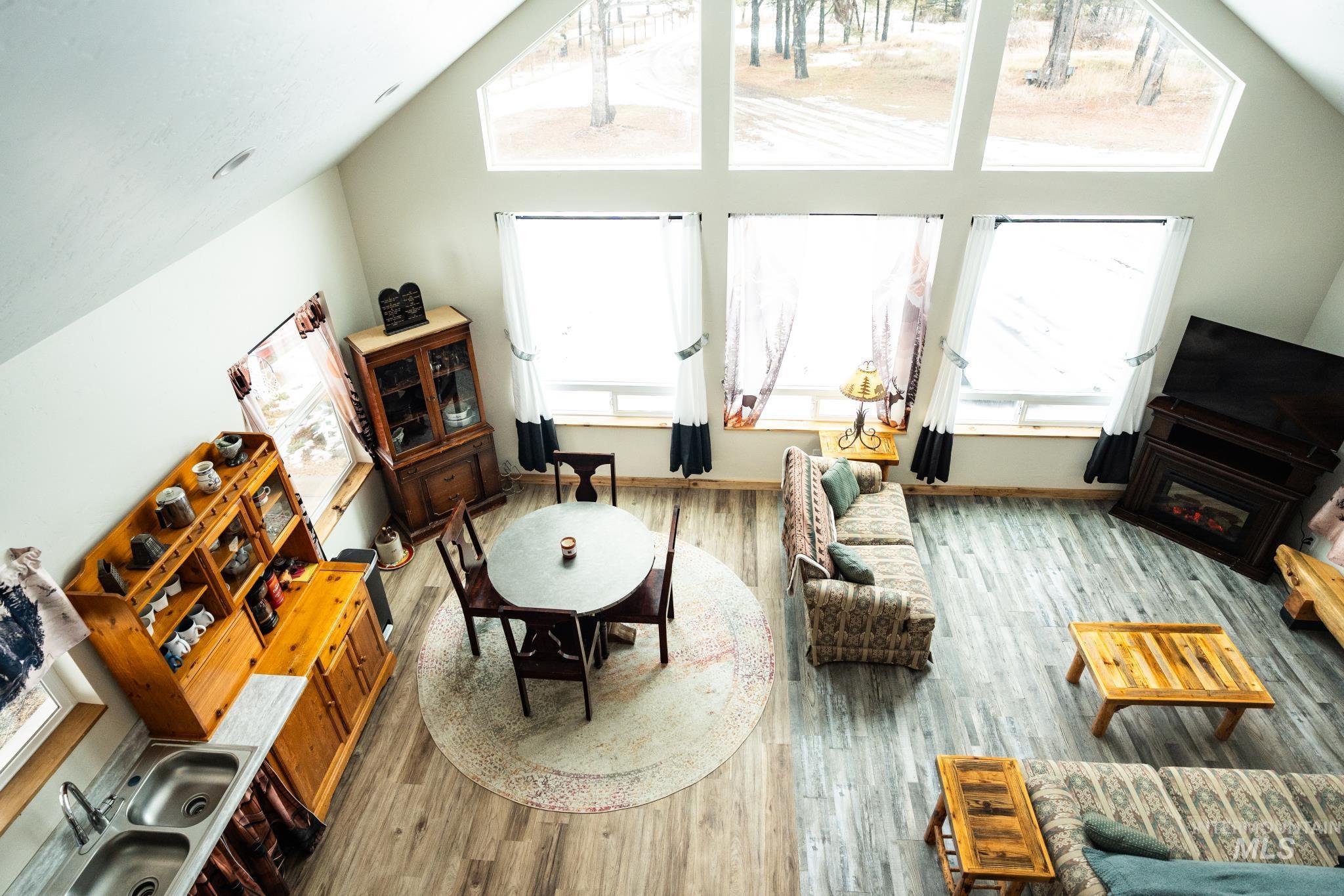 22 West Prospectors Drive Cascade, ID 83611 - Photo 9 of 25 Living room with healthy amount of natural light, light wood-type flooring, and high vaulted ceiling