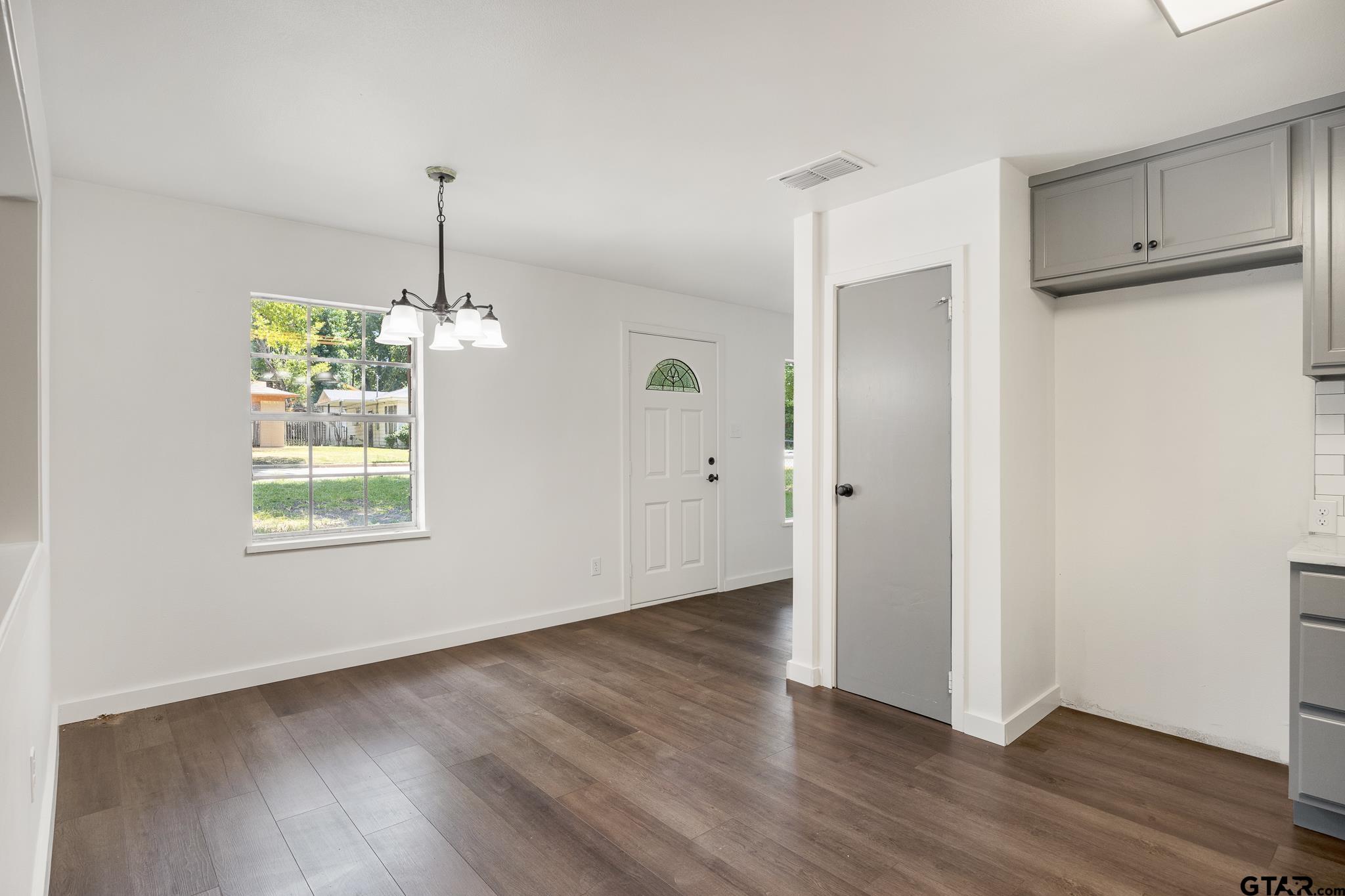 1538 North Hill Road Tyler, TX 75702 - Photo 13 of 29 a view of an empty room with wooden floor and a window