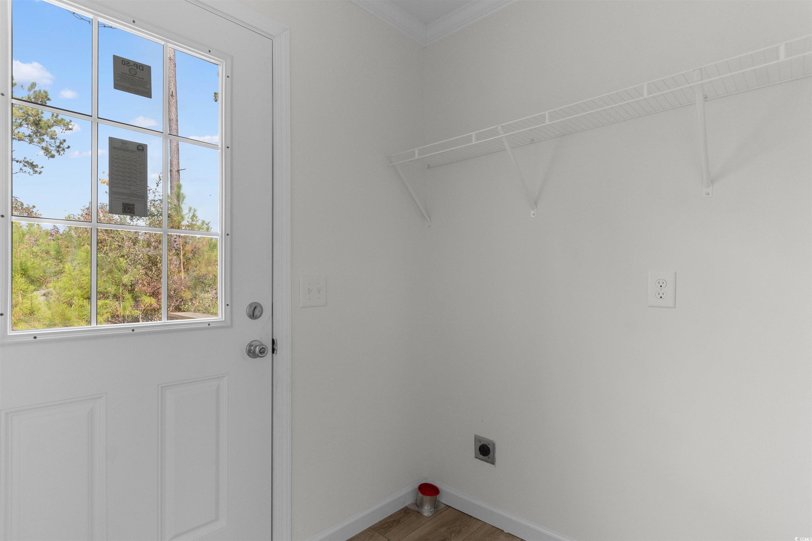 141 Feather Drive Georgetown, SC 29440 - Photo 18 of 34 Washroom with electric dryer hookup, crown molding, and light wood-style floors