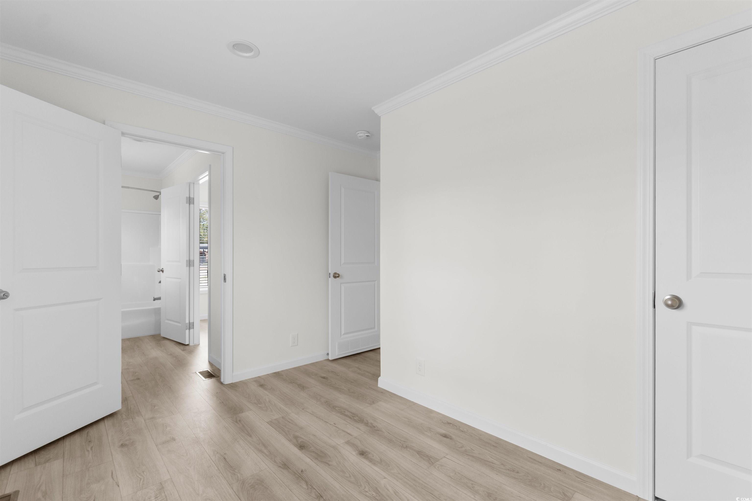 141 Feather Drive Georgetown, SC 29440 - Photo 22 of 34 Unfurnished bedroom with crown molding and light wood-type flooring