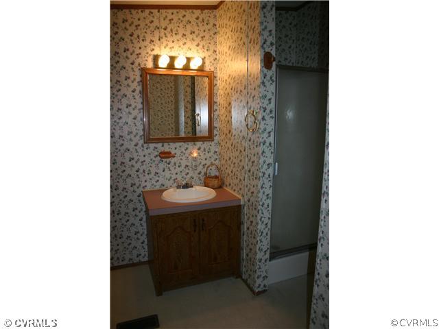 4900 Tabscott Road Kents Store, VA 23084 - Photo 9 of 9 a bathroom with a sink and mirror
