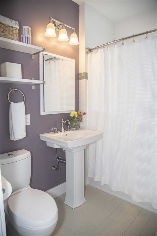 3 Chester Road, Unit 3 Belmont, MA 02478 - Photo 38 of 40 a bathroom with a sink a mirror and a toilet